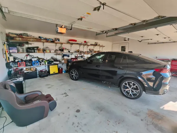 a garage with a couch and a chandelier