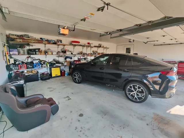 a garage with a couch and a chandelier