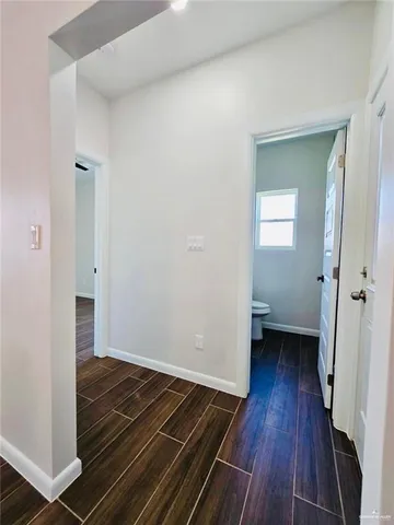 a view of an empty room and wooden floor