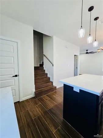 a room with wooden floor and staircase