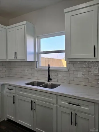a kitchen with a sink and cabinets
