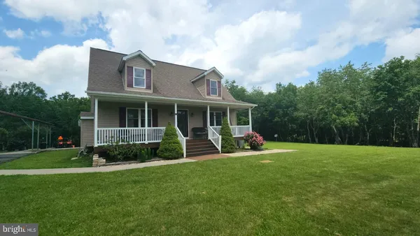 a view of a house with a yard and sitting area