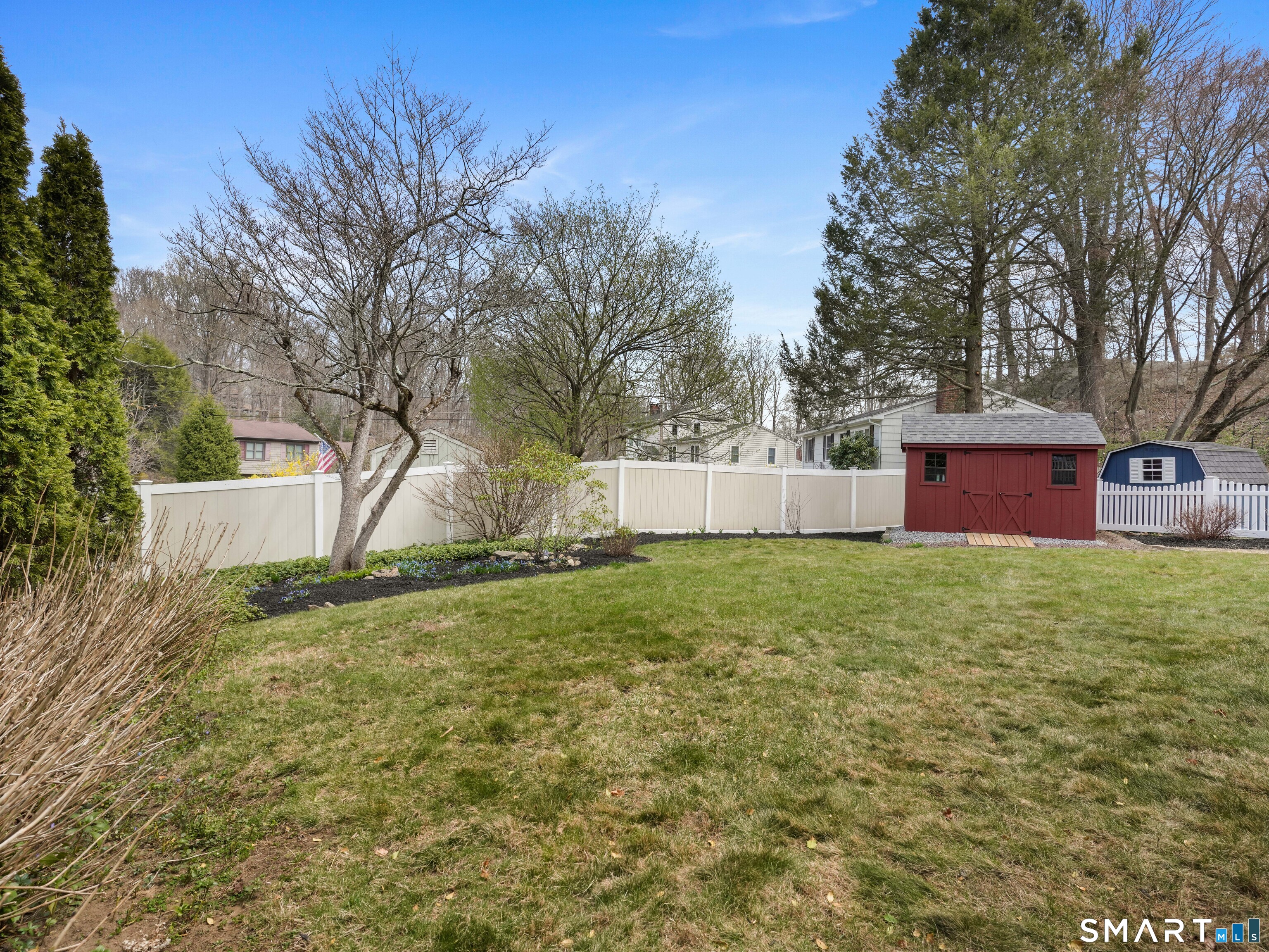 82 Ramapoo Road Ridgefield, CT 06877 - Photo 35 of 40 a backyard of a house with lots of green space
