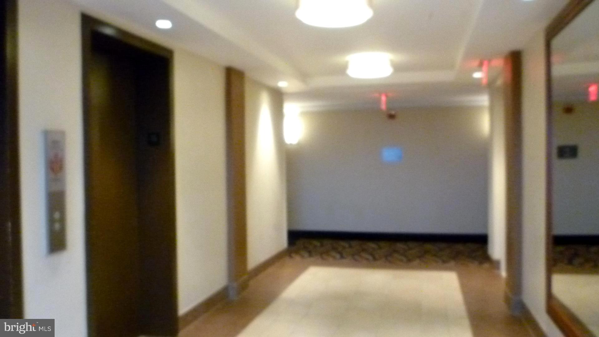 1111 University Boulevard West, Unit 1406A Silver Spring, MD 20902 - Photo 2 of 41 Hallway to Elevators