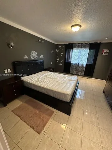 a bedroom with a bed and a night stand