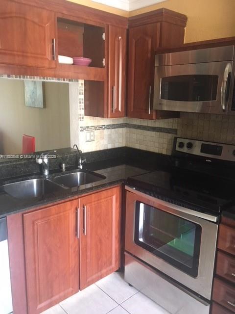 Atlantic Shores Hallandale Beach, FL 33009 - Photo 6 of 19 a kitchen with granite countertop wood cabinets stainless steel appliances and a sink