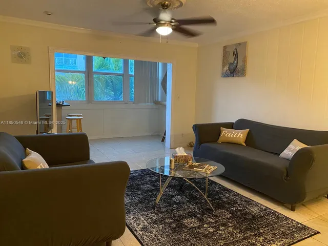a living room with furniture and a rug