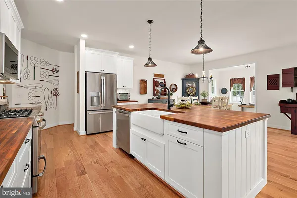 a stove top oven sitting inside of a kitchen