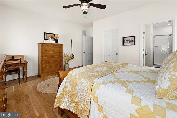 a bedroom with a bed and a lamp on dresser