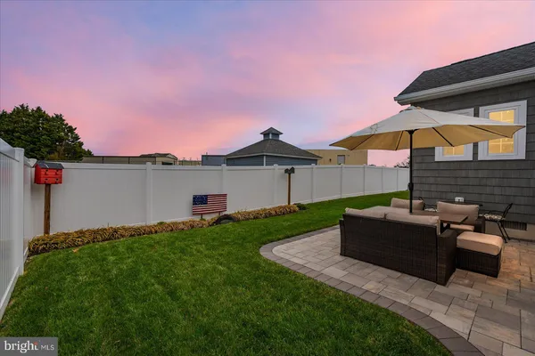 a backyard of a house with table and chairs