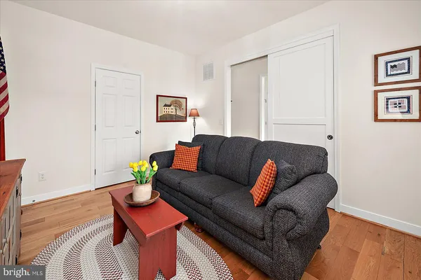 a view of a workspace with furniture and wooden floor