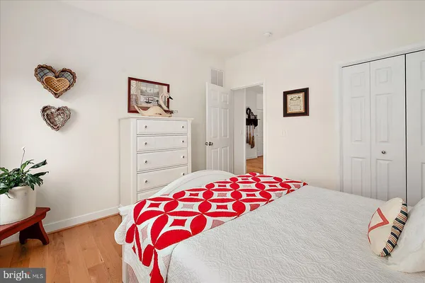 a kitchen with stainless steel appliances granite countertop a stove a microwave and white cabinets