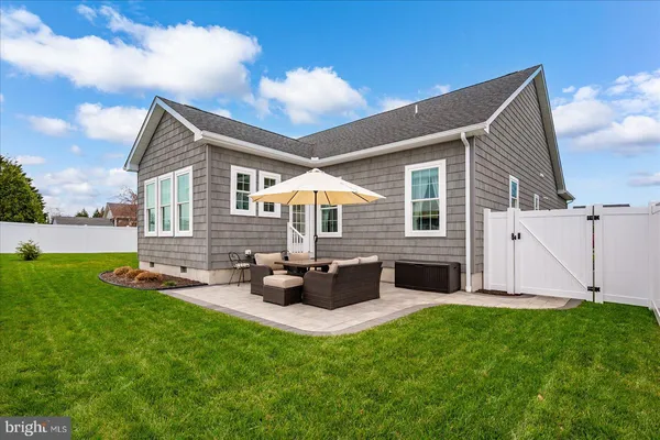 a backyard of a house with table and chairs