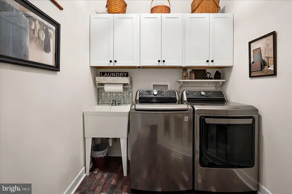 a view of a patio with couches table and chairs under an umbrella
