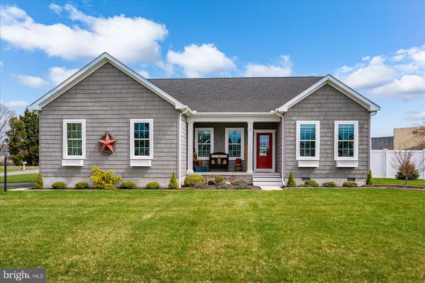 an aerial view of a house with swimming pool and a yard