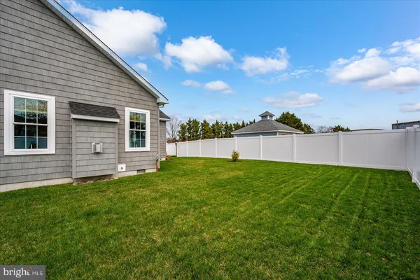a front view of a house with a garden and pathway