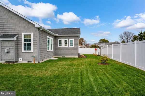 an aerial view of a house with a big yard