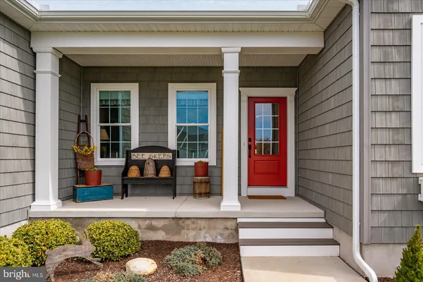 a kitchen with stainless steel appliances kitchen island granite countertop a refrigerator a stove a sink and a wooden floors