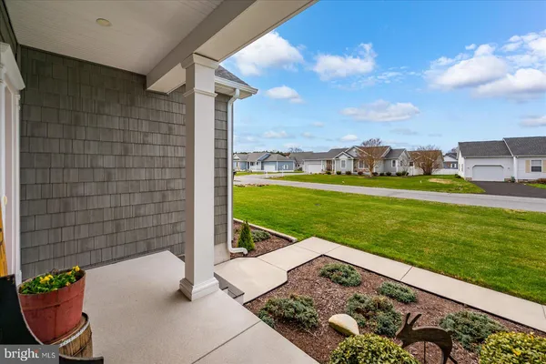 a kitchen with stainless steel appliances a stove a sink a microwave a refrigerator and white cabinets