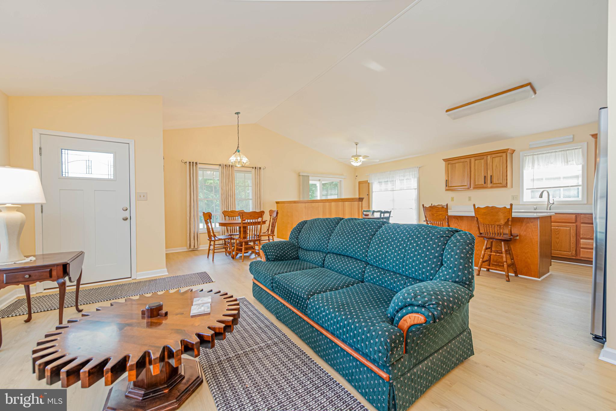 32408 Holly Ter Road Ocean View, DE 19970 - Photo 18 of 51 a living room with furniture and a dining table with wooden floor