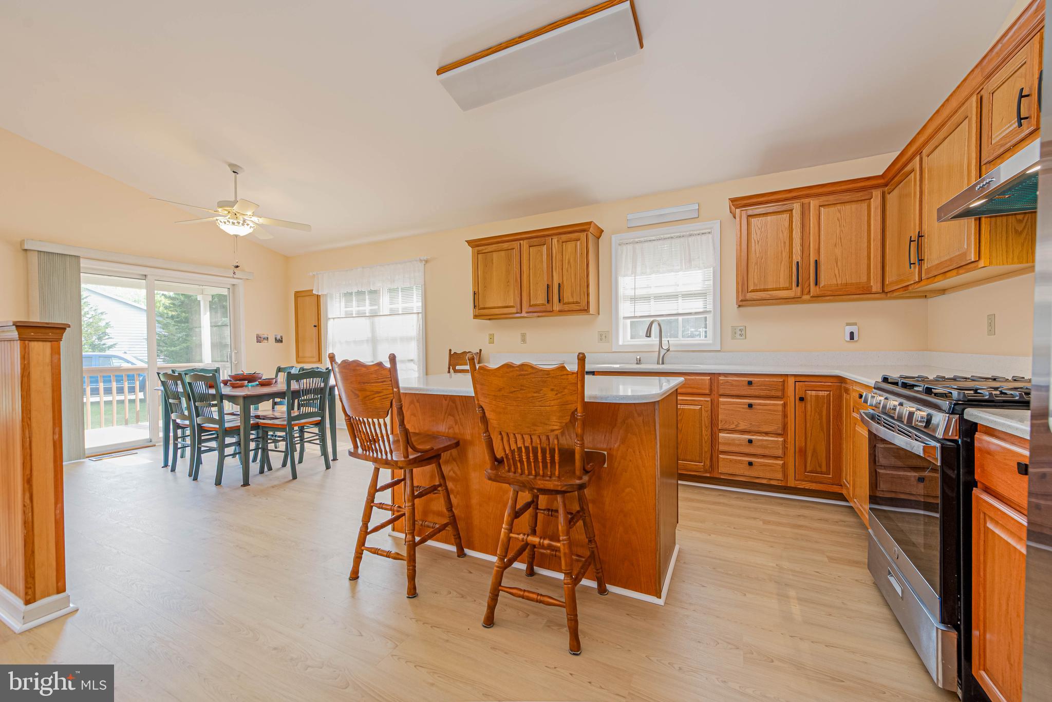 32408 Holly Ter Road Ocean View, DE 19970 - Photo 20 of 51 a kitchen with stainless steel appliances granite countertop a table and chairs in it