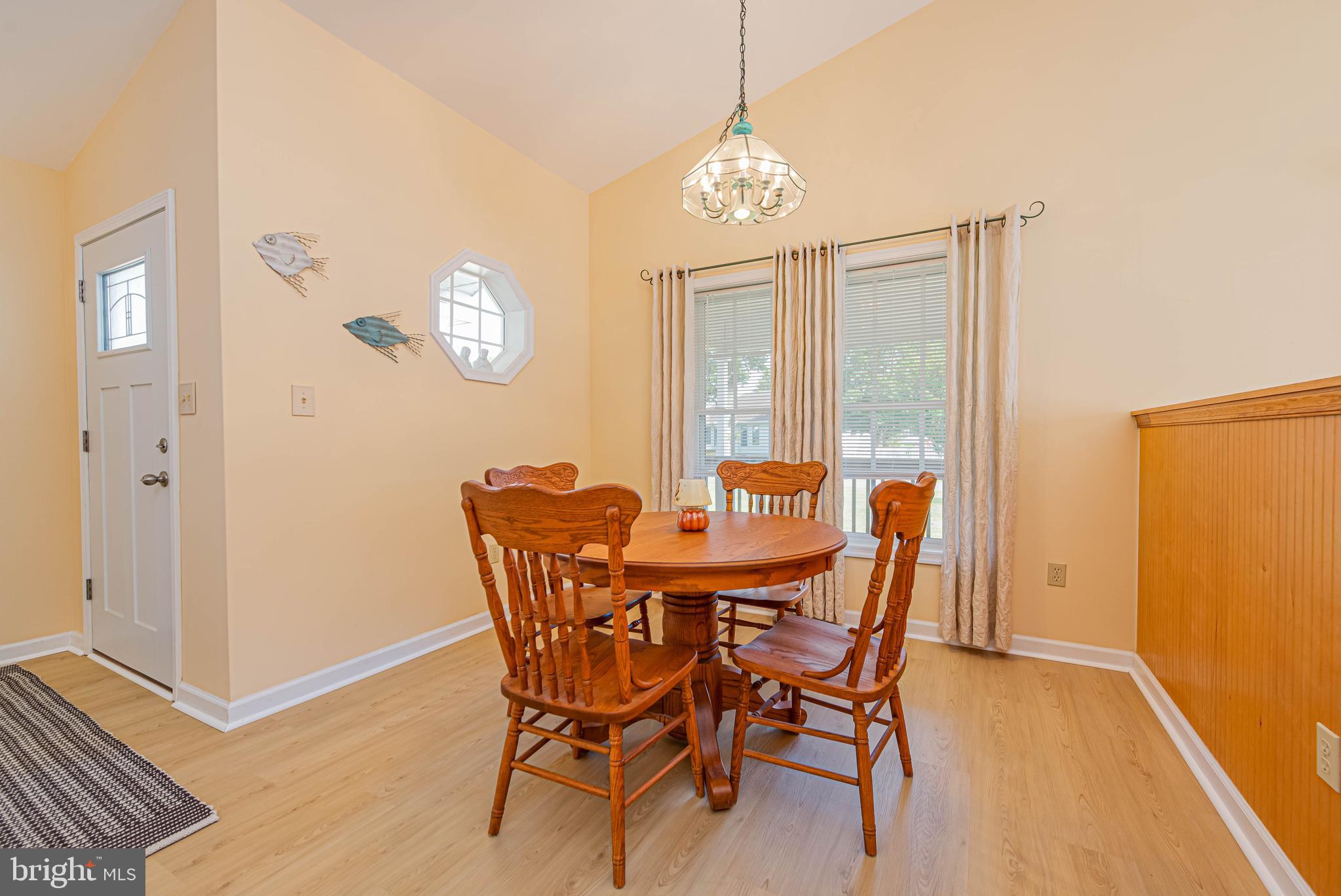 32408 Holly Ter Road Ocean View, DE 19970 - Photo 21 of 51 a view of a dining room with furniture and chandelier