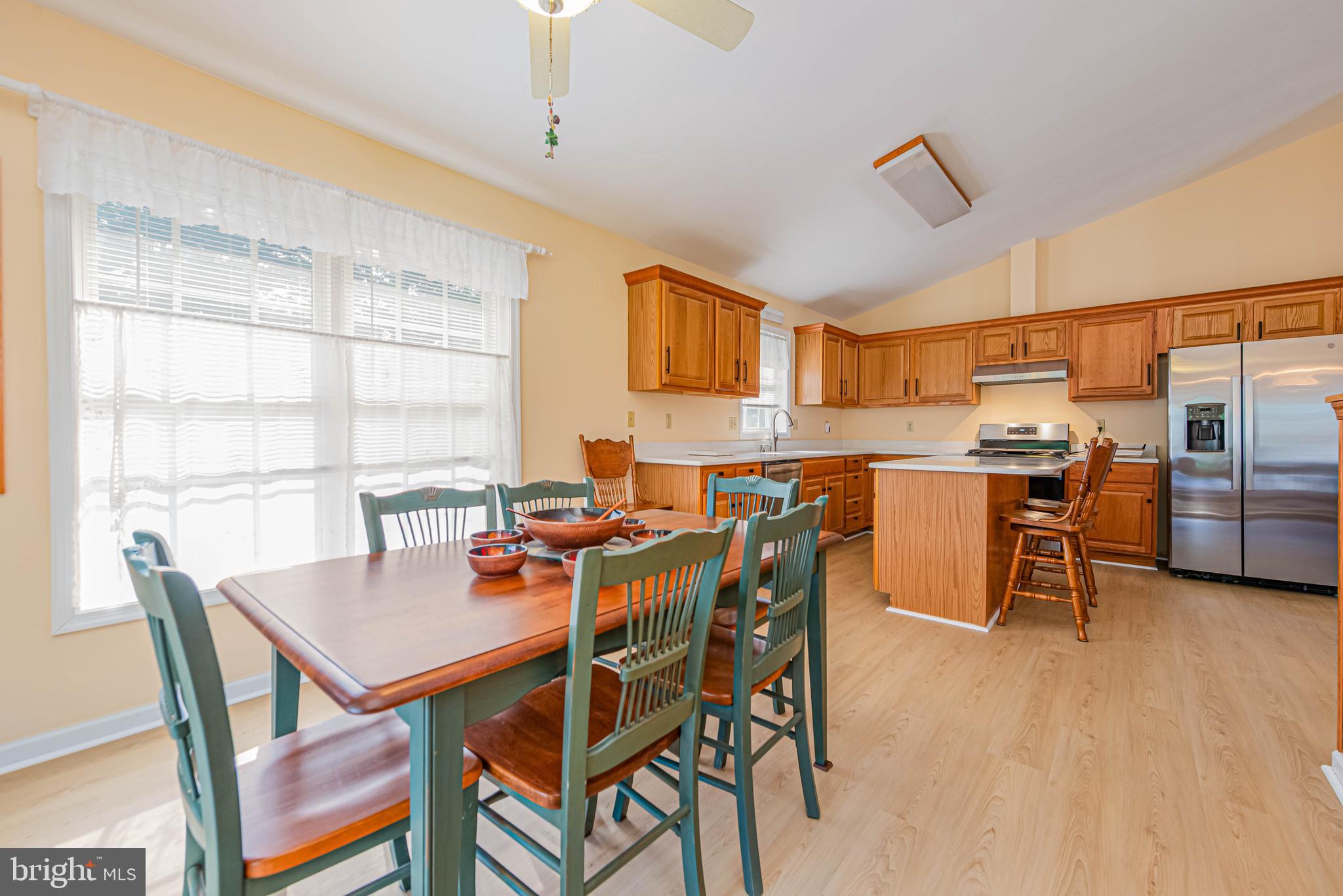 32408 Holly Ter Road Ocean View, DE 19970 - Photo 24 of 51 a dining room with a table chairs and a kitchen view
