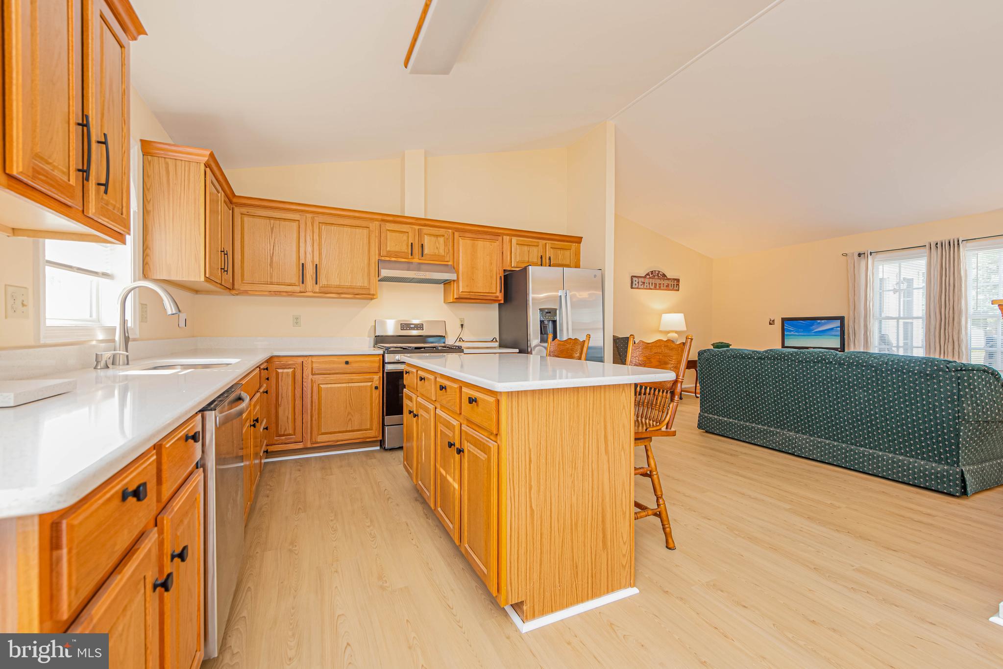 32408 Holly Ter Road Ocean View, DE 19970 - Photo 25 of 51 a kitchen with stainless steel appliances kitchen island granite countertop a sink and cabinets