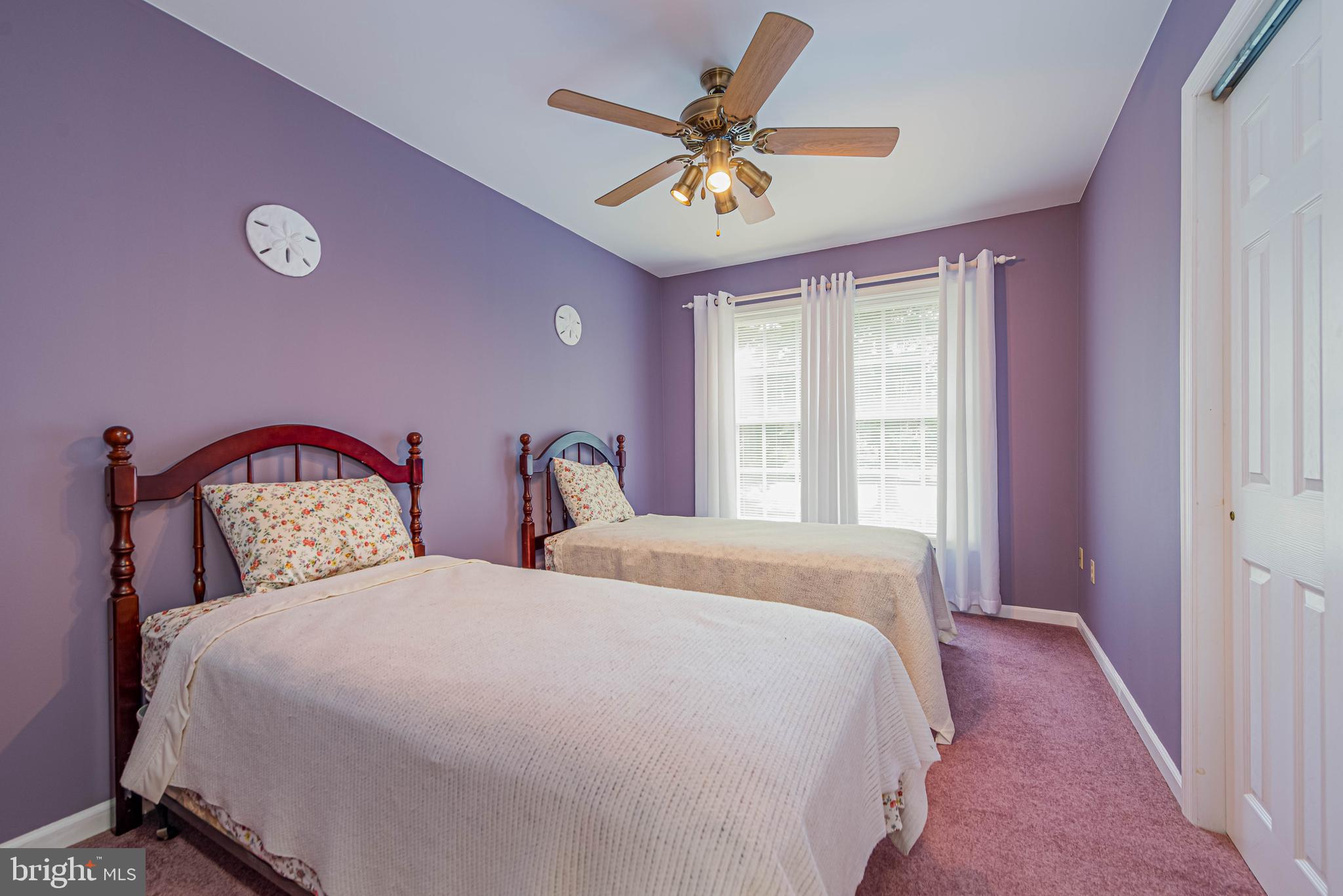 32408 Holly Ter Road Ocean View, DE 19970 - Photo 30 of 51 a bedroom with two beds and a window