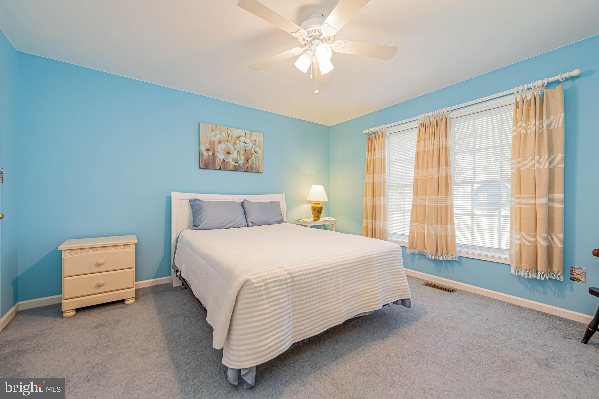 32408 Holly Ter Road Ocean View, DE 19970 - Photo 35 of 51 a spacious bedroom with a bed and a window
