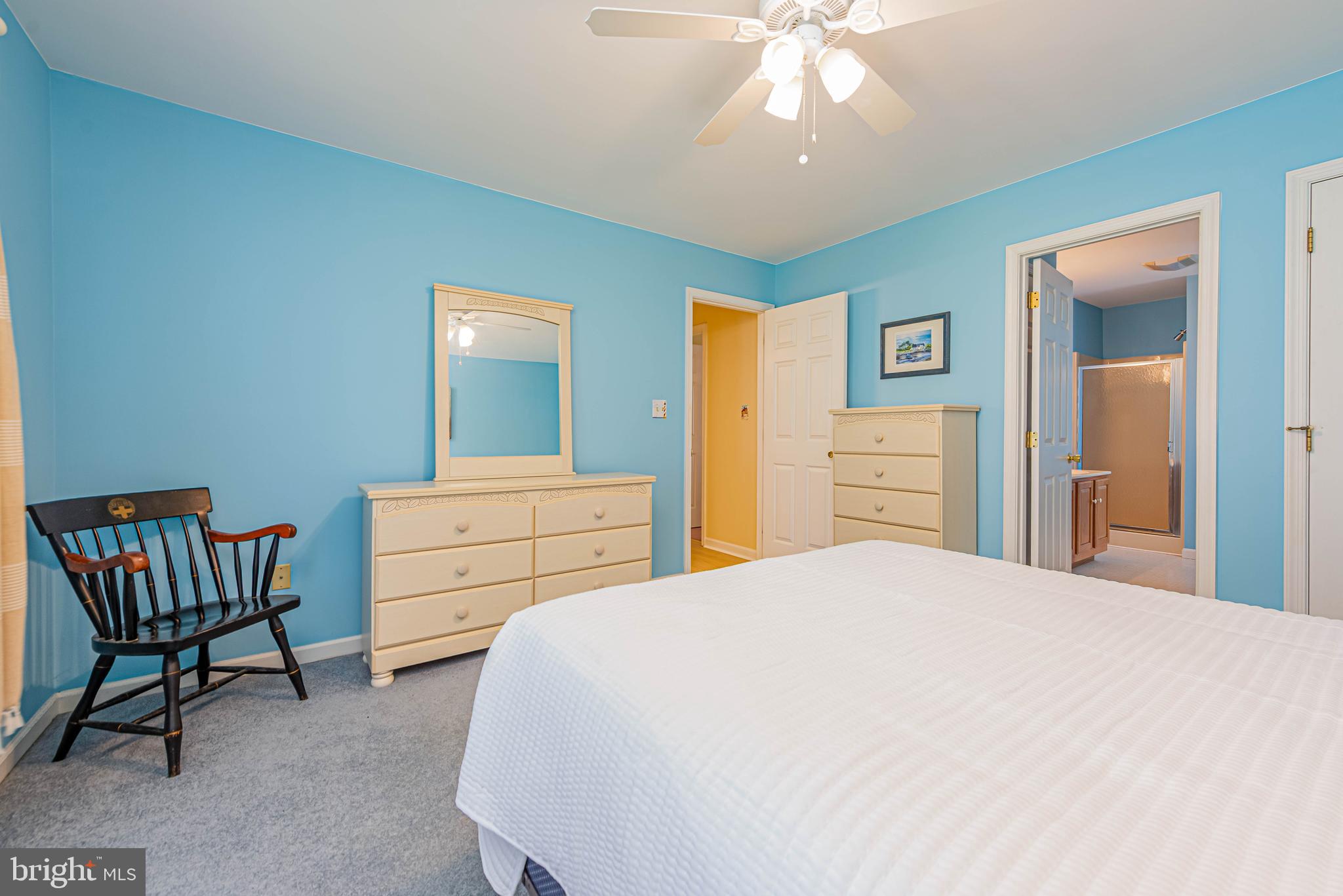 32408 Holly Ter Road Ocean View, DE 19970 - Photo 37 of 51 a bedroom with a bed and a chandelier