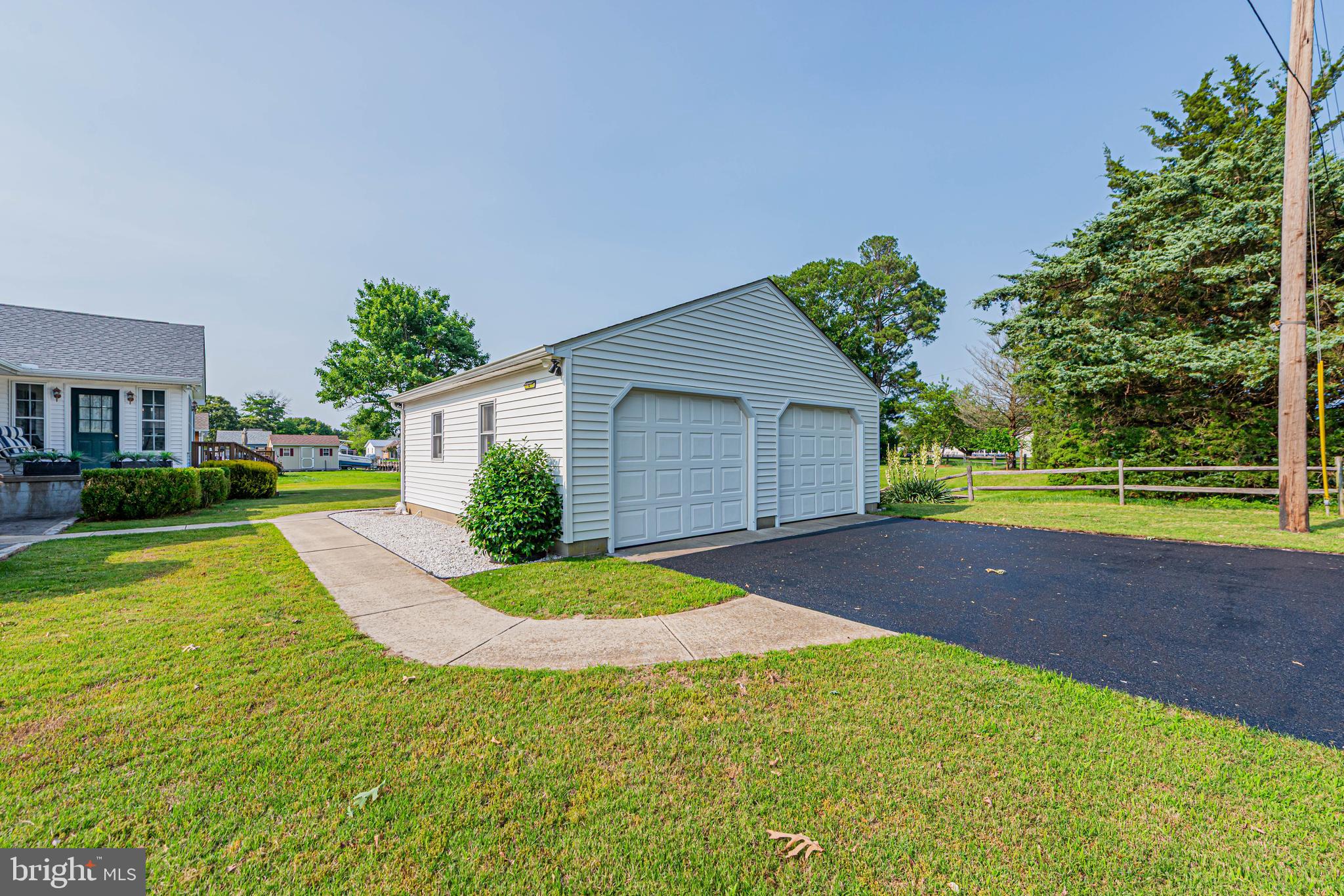 32408 Holly Ter Road Ocean View, DE 19970 - Photo 4 of 51 a view of yellow house with a yard and garage