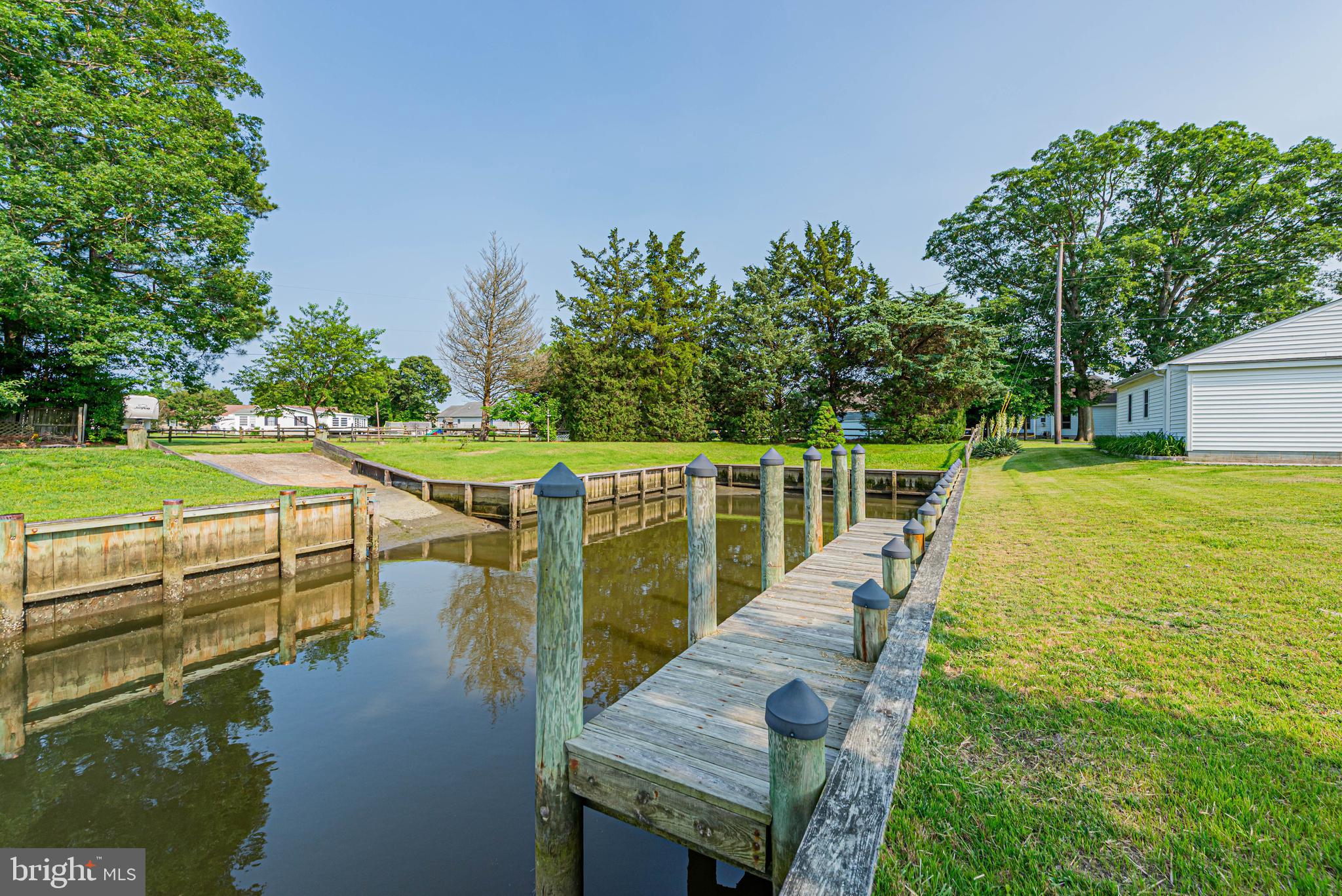 32408 Holly Ter Road Ocean View, DE 19970 - Photo 9 of 51 a view of a lake with couches and wooden fence