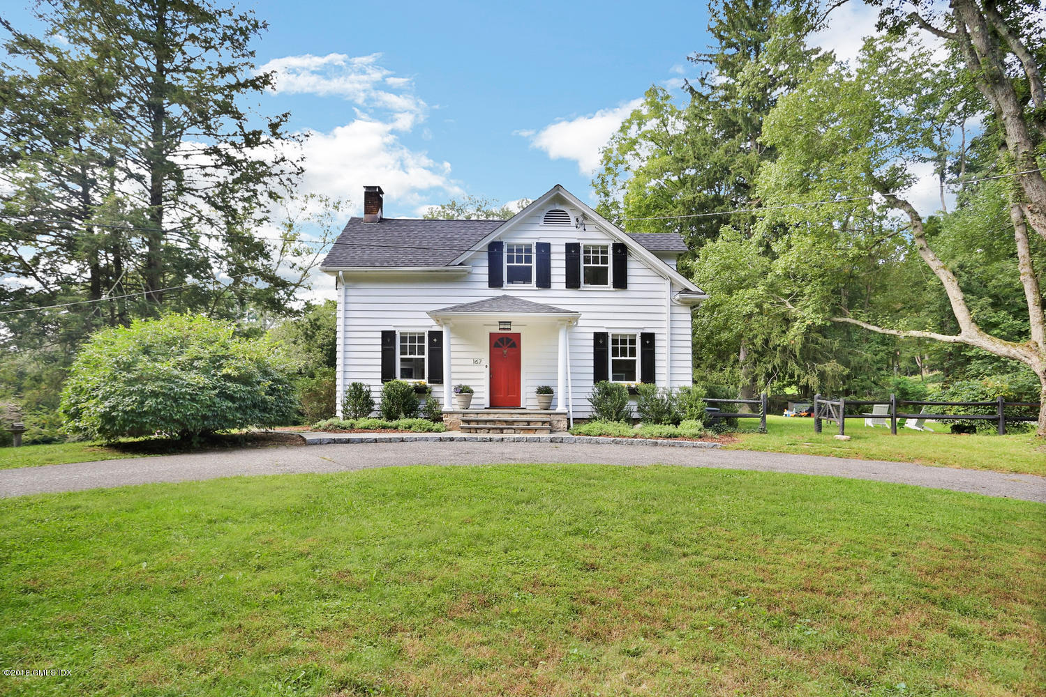 167 Riverbank Road Stamford, CT 06903 - Photo 1 of 38 a view of a house with a yard and potted plants