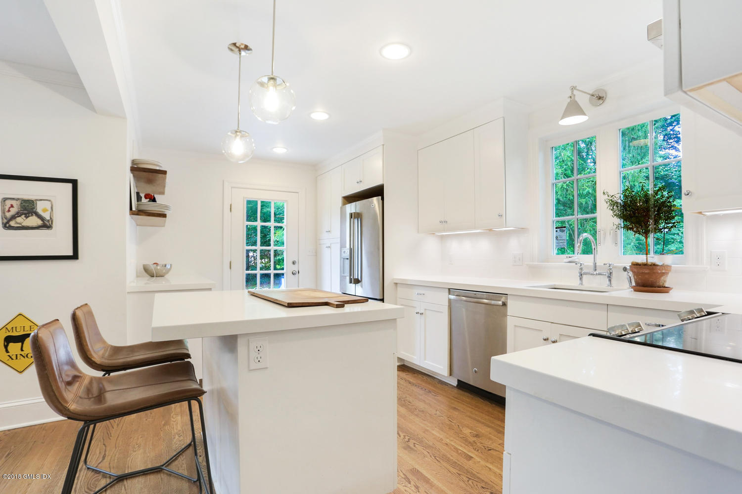 167 Riverbank Road Stamford, CT 06903 - Photo 15 of 38 a kitchen with a stove a sink a dining table and chairs