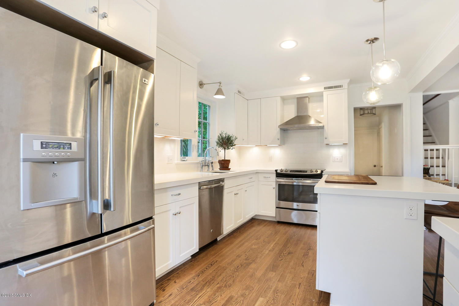 167 Riverbank Road Stamford, CT 06903 - Photo 16 of 38 a kitchen with white cabinets and stainless steel appliances
