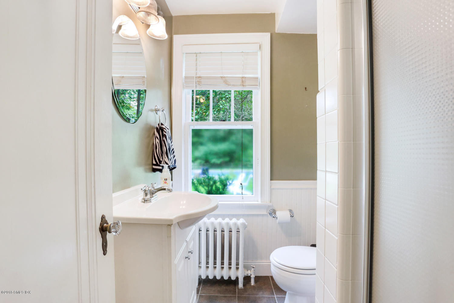 167 Riverbank Road Stamford, CT 06903 - Photo 19 of 38 a bathroom with a sink a toilet and a window