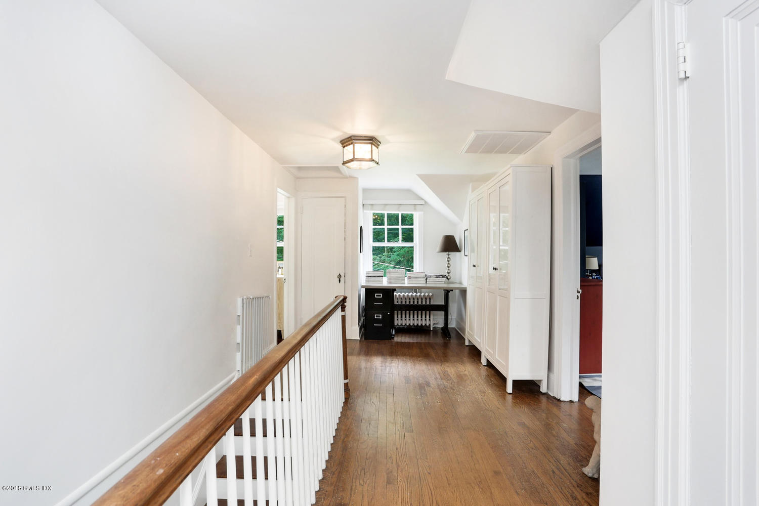 167 Riverbank Road Stamford, CT 06903 - Photo 20 of 38 a view of a hallway with wooden floor and staircase