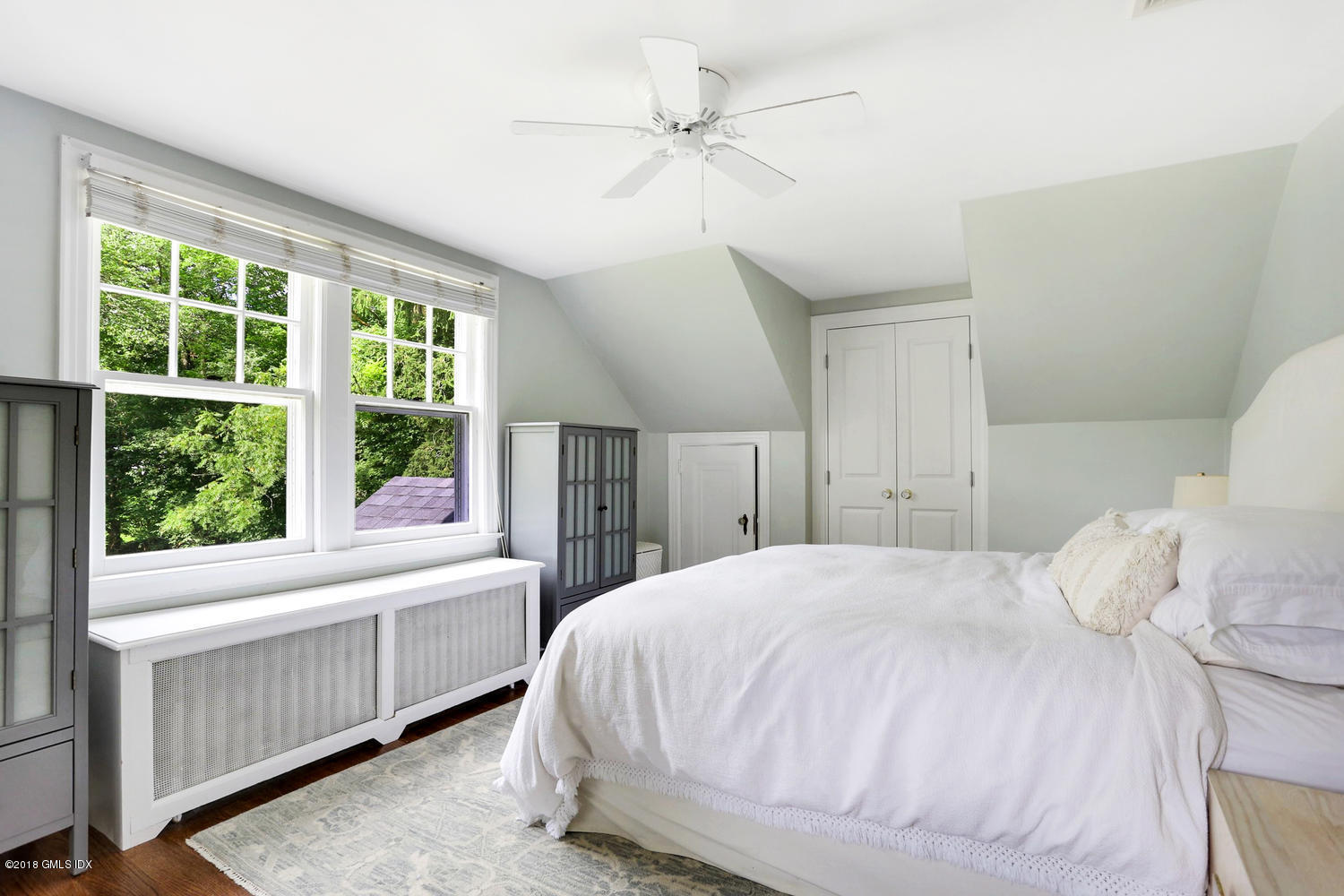 167 Riverbank Road Stamford, CT 06903 - Photo 23 of 38 a bedroom with a large bed and a window