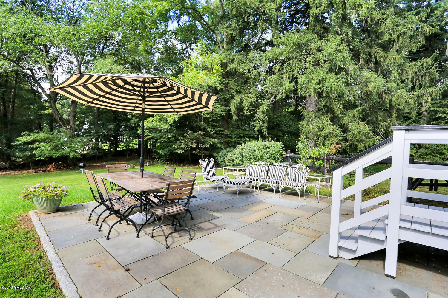 167 Riverbank Road Stamford, CT 06903 - Photo 26 of 38 a view of backyard with seating space and trees