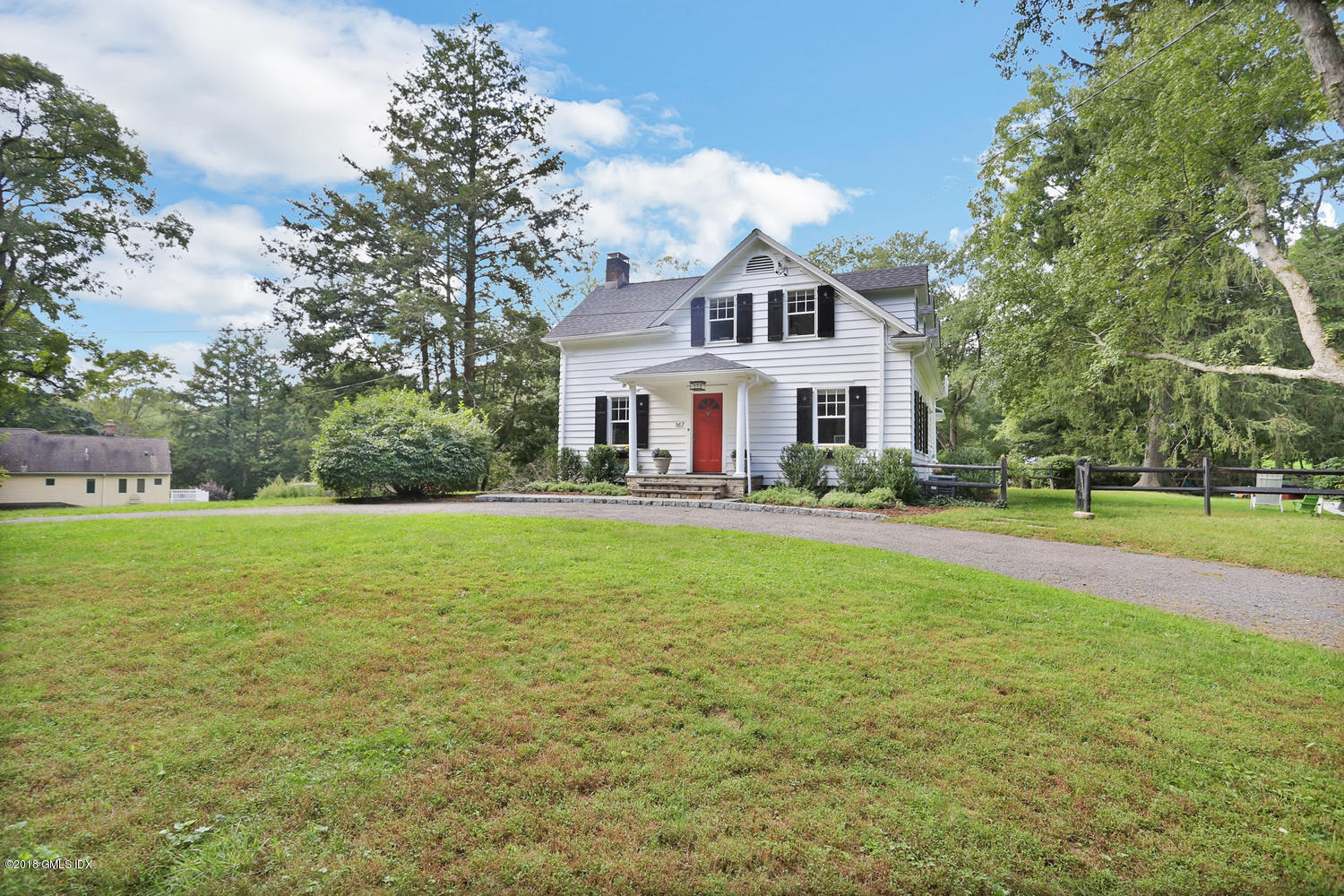 167 Riverbank Road Stamford, CT 06903 - Photo 29 of 38 a front view of a house with a yard