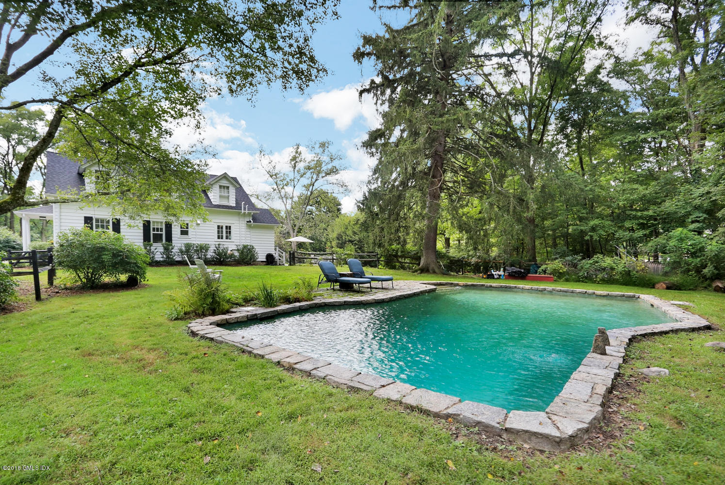 167 Riverbank Road Stamford, CT 06903 - Photo 33 of 38 a view of a house with a back yard