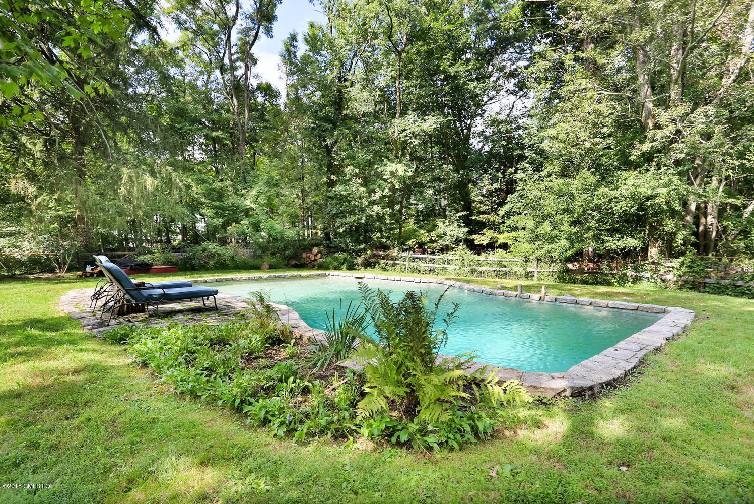 167 Riverbank Road Stamford, CT 06903 - Photo 34 of 38 a view of a swimming pool with a yard and sitting area