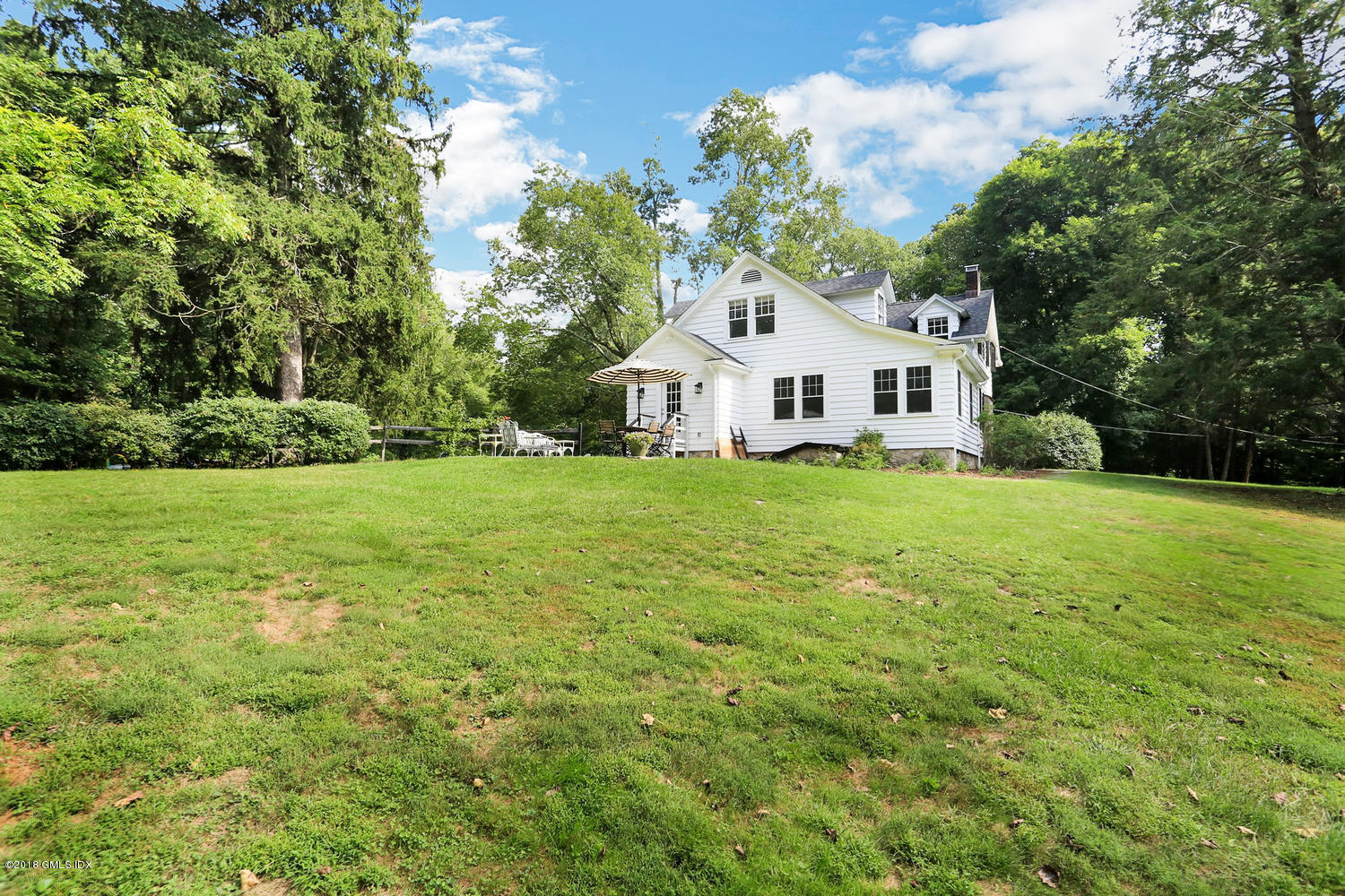 167 Riverbank Road Stamford, CT 06903 - Photo 35 of 38 a view of a house with a big yard and large trees