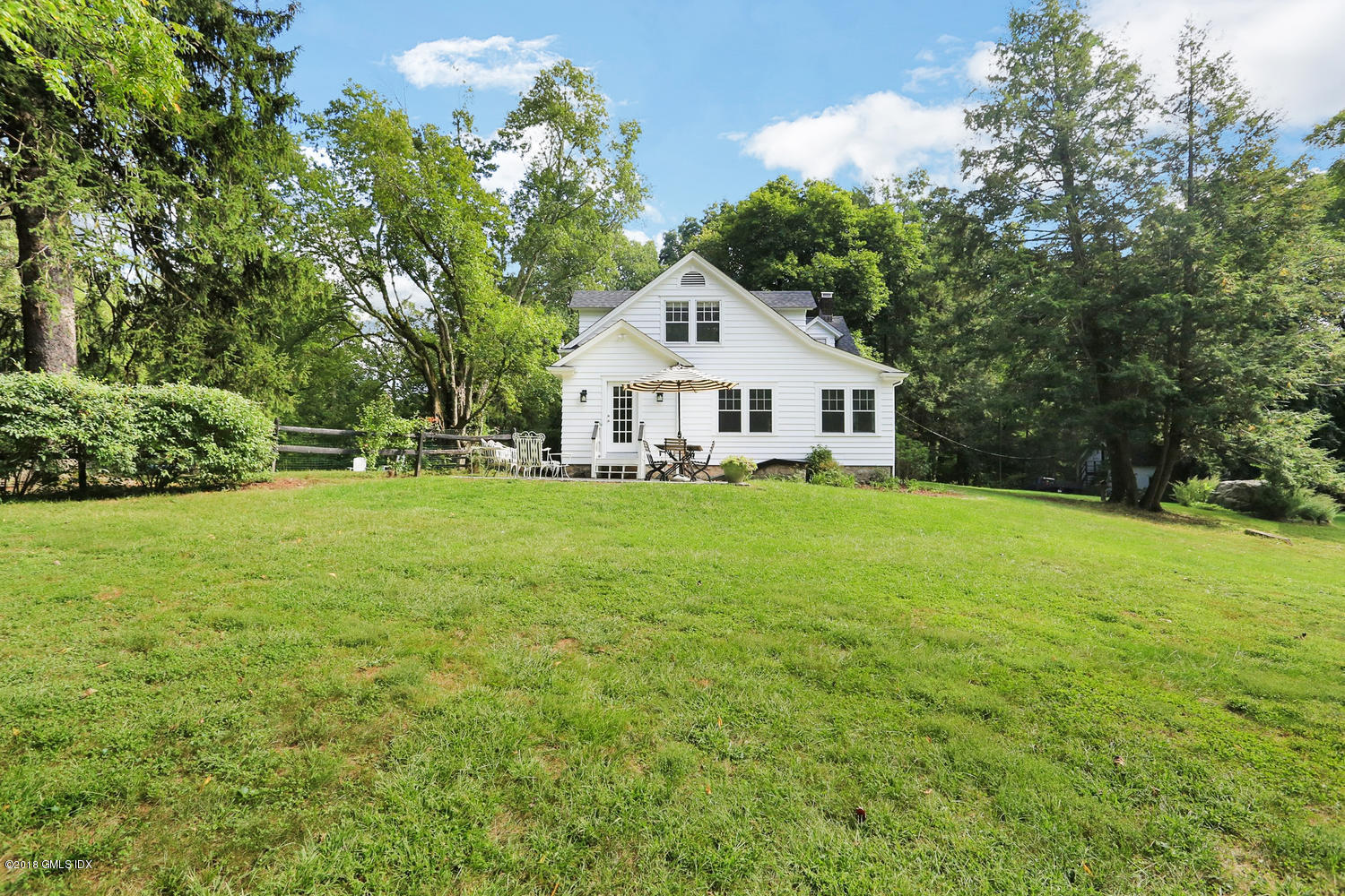 167 Riverbank Road Stamford, CT 06903 - Photo 36 of 38 a front view of a house with garden