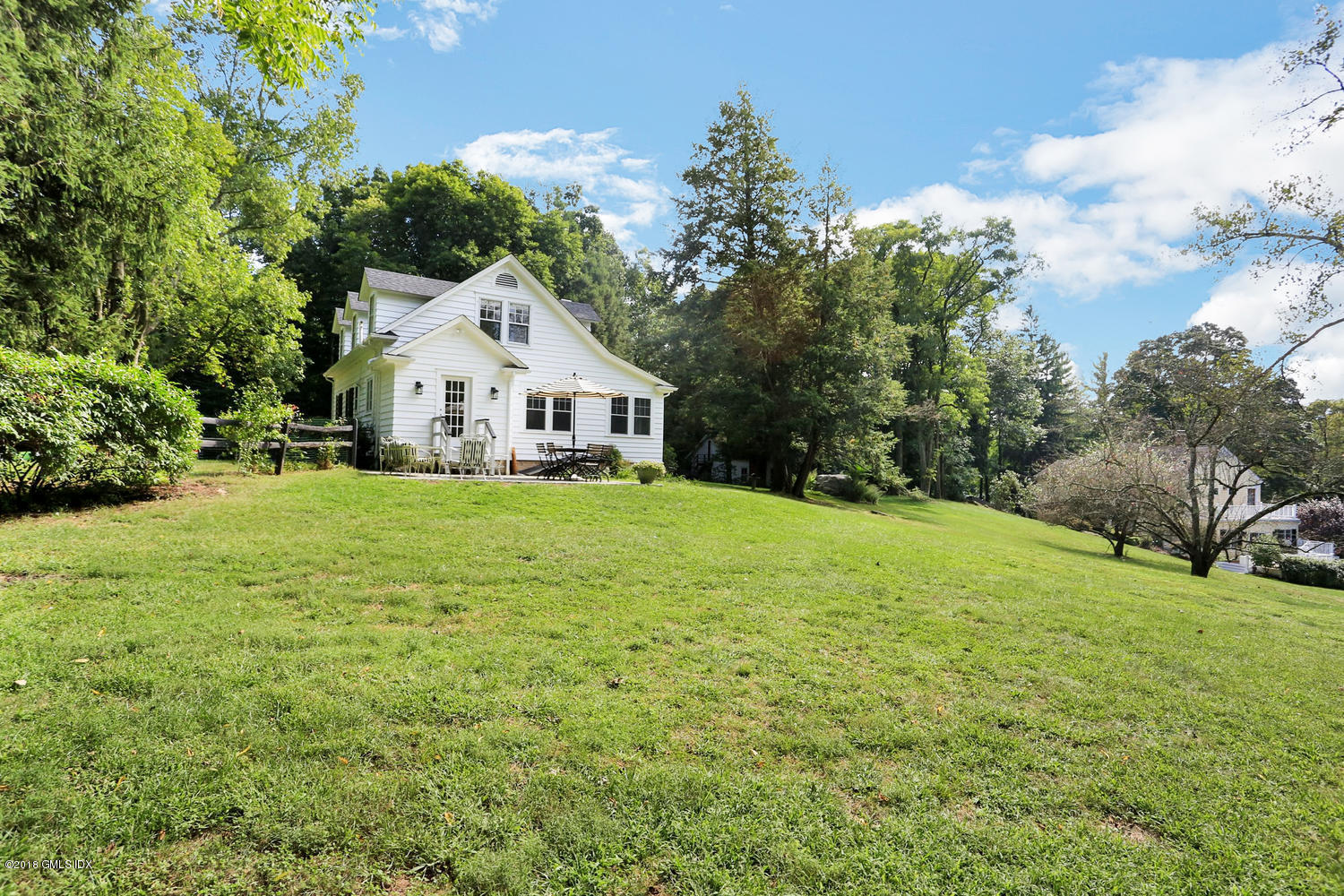 167 Riverbank Road Stamford, CT 06903 - Photo 37 of 38 a front view of a house with yard and green space