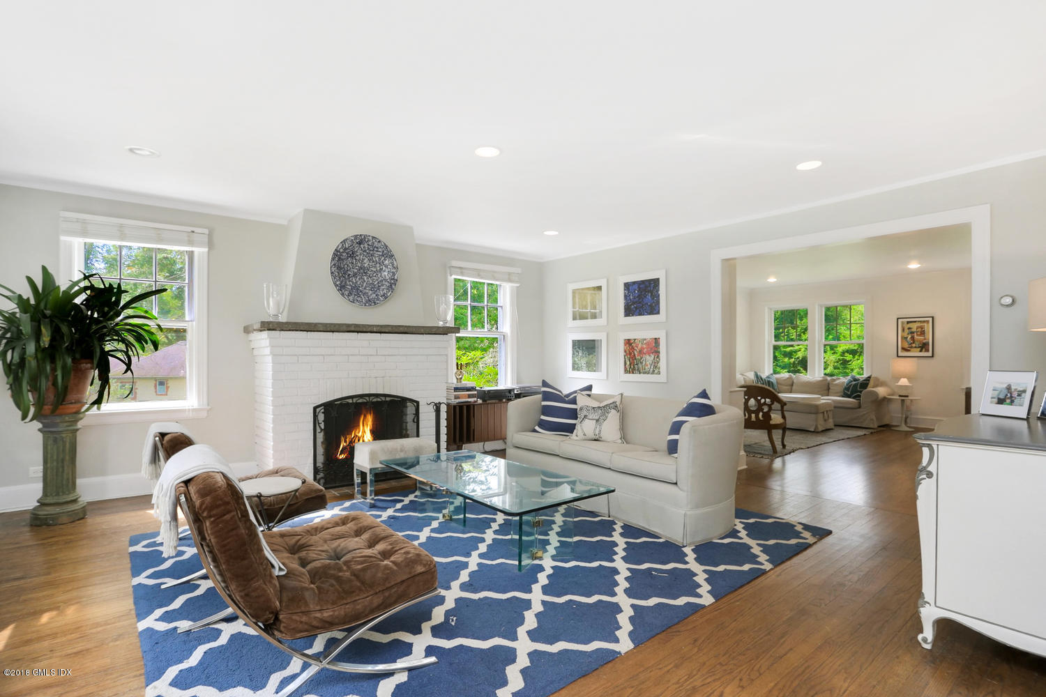 167 Riverbank Road Stamford, CT 06903 - Photo 4 of 38 a living room with furniture a fireplace and a large window