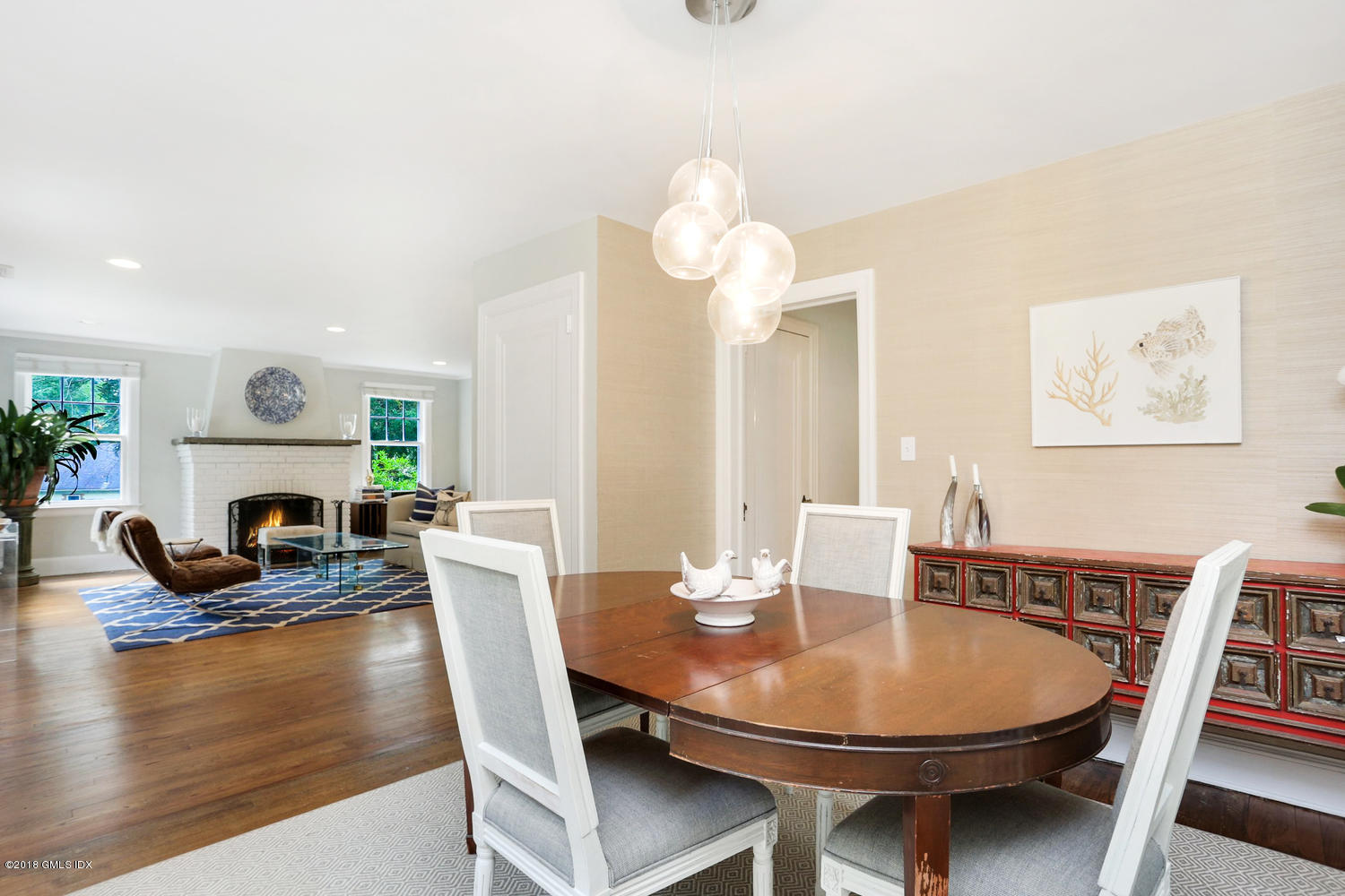 167 Riverbank Road Stamford, CT 06903 - Photo 8 of 38 a view of a dining room with furniture a chandelier and wooden floor
