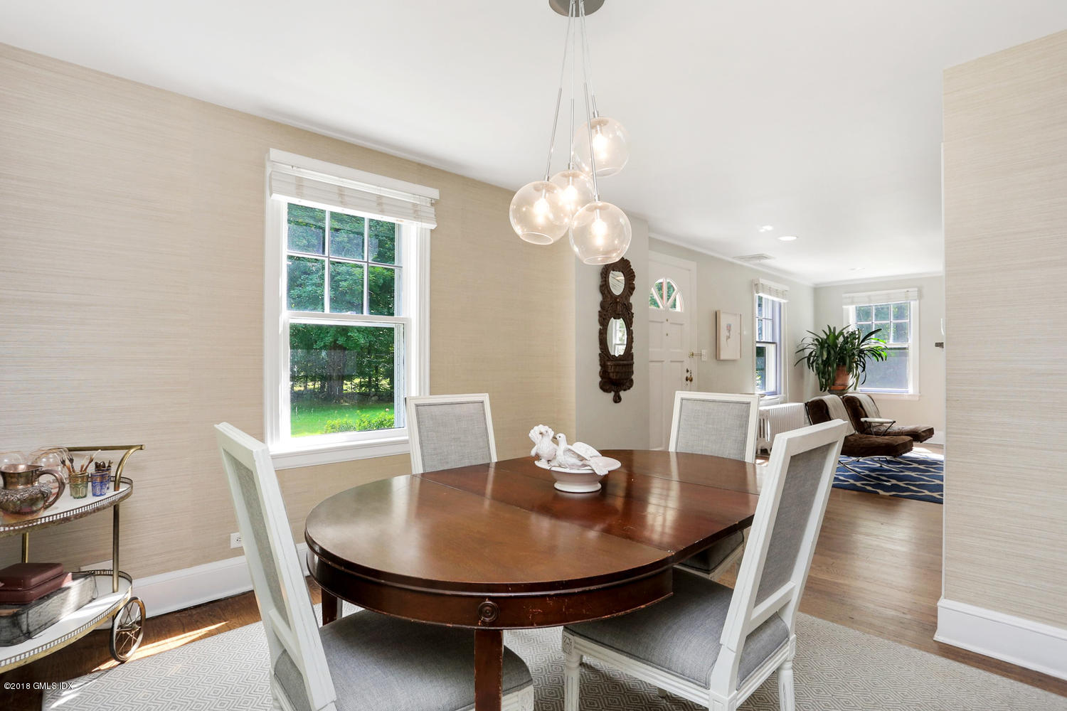 167 Riverbank Road Stamford, CT 06903 - Photo 9 of 38 a view of a dining room with furniture and a potted plant