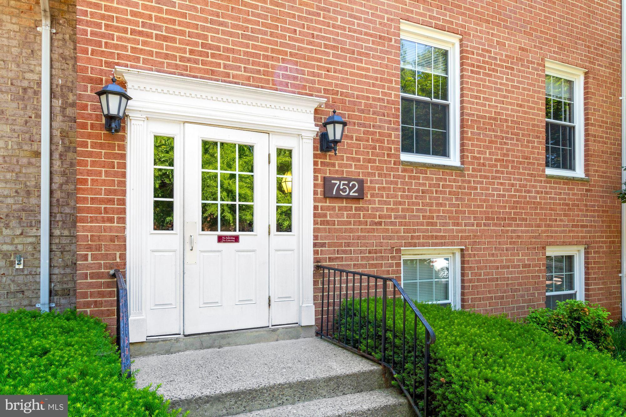a view of a brick house with plants